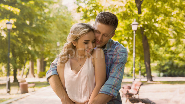 Young couple of lovers gently embracing rejoicing see each other, date in park Stock photo © motortion