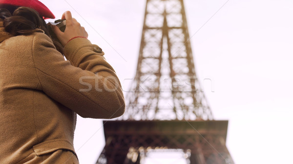 Stock photo: Female tourist photographing Eiffel Tower, spending vacation in Paris, travel