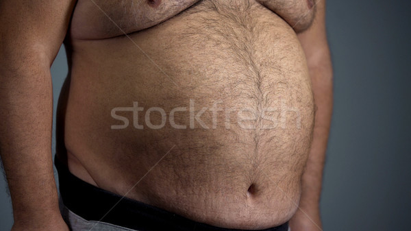 Big belly of unhealthy adult man, junk food overeating problem, overweight Stock photo © motortion