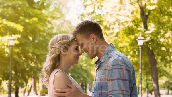 Couple in love gently embracing, enjoying each other on date in park, first love Stock photo © motortion