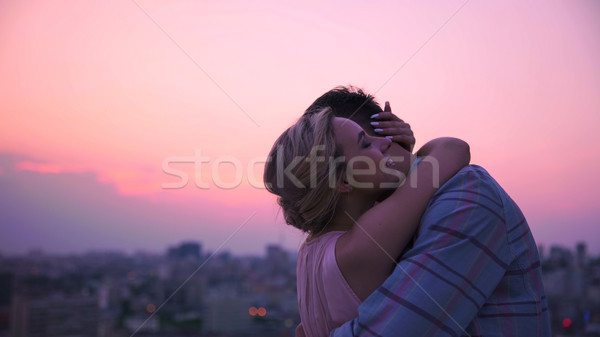 Lady tenderly and gently hugging her boyfriend dissolving in warmth of his body Stock photo © motortion