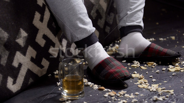 Messy floor with food leftovers, closeup of lazy jobless bachelor man slippers Stock photo © motortion
