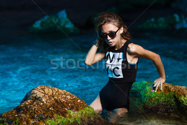 Stock photo: Young teen girl in sea fashion shoot at sunset beach