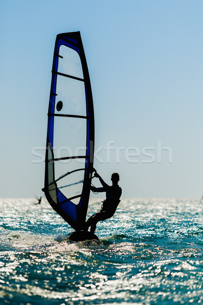 windsurfer silhouette against sun Stock photo © mrakor