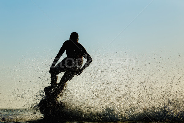 Siluetă zbura bord plajă om sportiv Imagine de stoc © mrakor