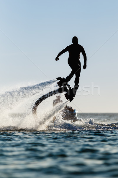 Sylwetka latać pokładzie plaży człowiek sportu Zdjęcia stock © mrakor