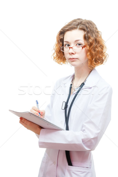 cute redhead doctor in lab coat and glasses with nothebook Stock photo © mrakor