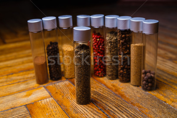 Assorted spices in bottles on wooden background Stock photo © mrakor