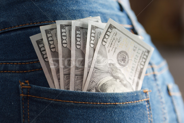 Pack of dollar banknotes in woman jeans pocket Stock photo © mrakor