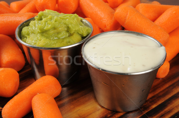 Fresh baby carrots with dips Stock photo © MSPhotographic