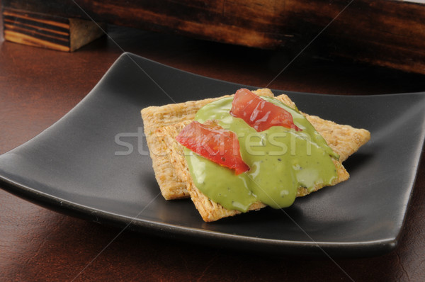 Guacamole and tomato on cracker Stock photo © MSPhotographic