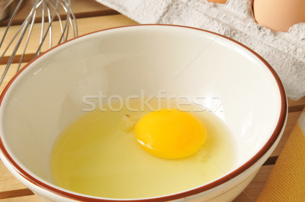 Stock photo: Raw egg in a mixing bowl