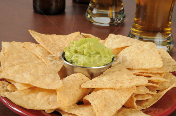 Plate of tortilla chips and guacamole on a bar counter Stock photo © MSPhotographic