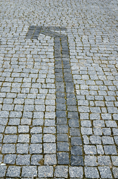 cobbled road with arrow as background Stock photo © mycola