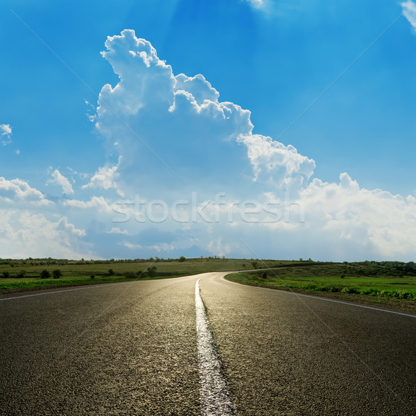 asphalt road closeup under cloudy blue sky stock photo ...