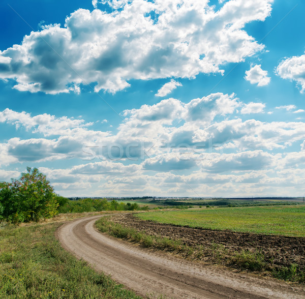 Stock photo: winding rural road to cloudy horizon