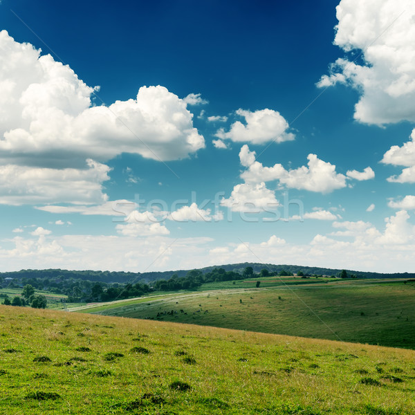 view to green hills and deep blue sky with low clouds over it Stock photo © mycola