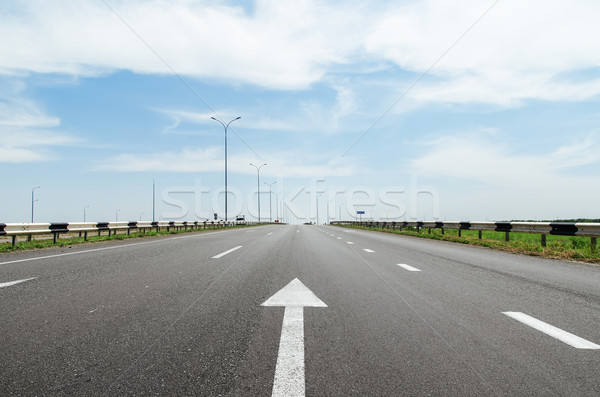 white arrow on asphalt road Stock photo © mycola