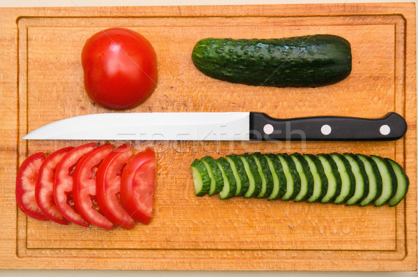 red tomato and green cucumbers slices with knife on board Stock photo © mycola
