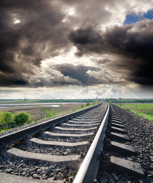 view to railroad goes to horizon under cloudy sky with sun Stock photo © mycola