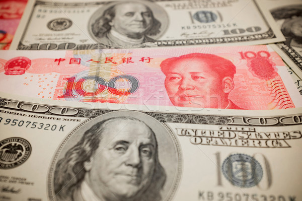 Chinese Yuan Note and U.S. dollar background  (Exchange rate concept) Stock photo © myfh88