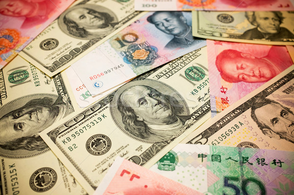 Chinese Yuan Note and U.S. dollar background  (Exchange rate concept) Stock photo © myfh88