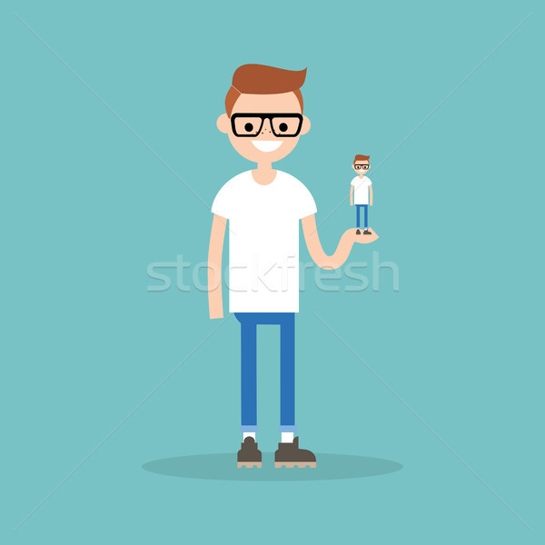 Stock photo: Self presentation. Young character holding his 3D model on the p