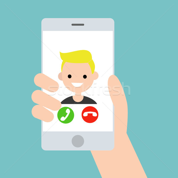 Hand holding a smart phone. Incoming call from young blond boy / Stock photo © nadia_snopek