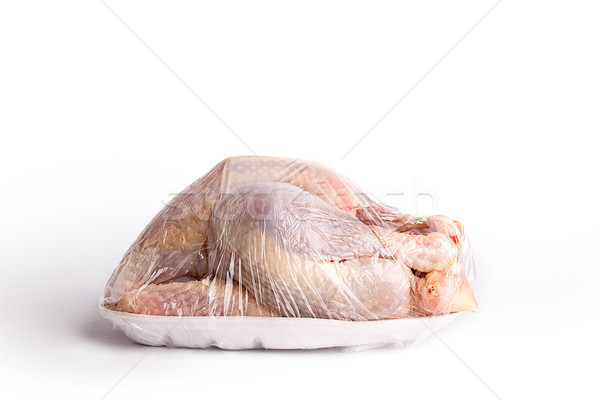 Raw whole chicken in plastic wrapping Stock photo © nailiaschwarz