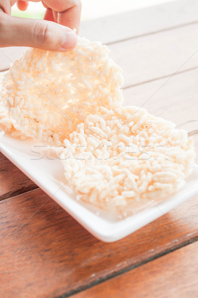 Hand hold thai style crispy rice cracker Stock photo © nalinratphi