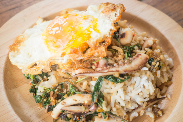 Rice topped with stir-fried squid basil and fried egg (Thai food Stock photo © nalinratphi