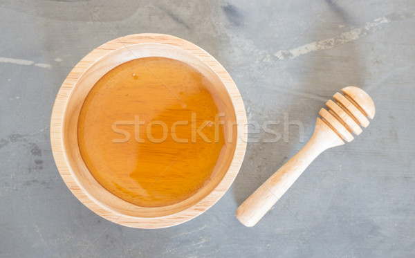 Stock photo: Golden honey cup and dipper on top view