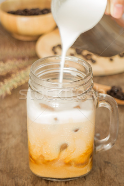 Milk pouring for fresh iced coffee Stock photo © nalinratphi