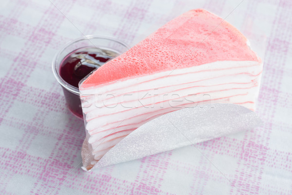 Stock photo: Pink crepe cake and blueberry sauce