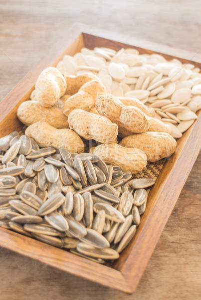 Assorted of whole grain sunflower, peanut and pumpkin on wooden  Stock photo © nalinratphi