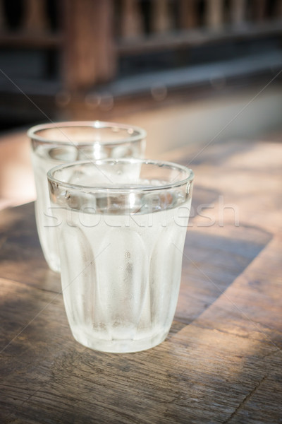 Double glasses of cold water on wooden table Stock photo © nalinratphi