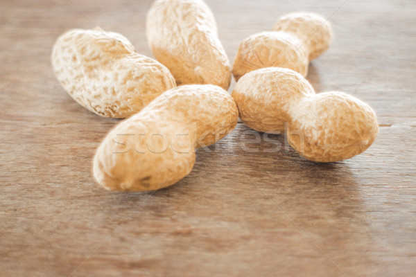 Salted peanuts on weathered wood Stock photo © nalinratphi