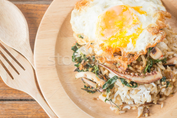 Rice topped with stir-fried squid basil and fried egg (Thai food Stock photo © nalinratphi