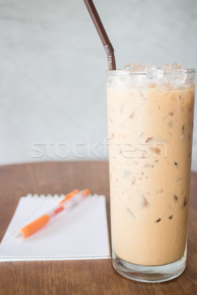 Glass of cold milk coffee on wooden table Stock photo © nalinratphi