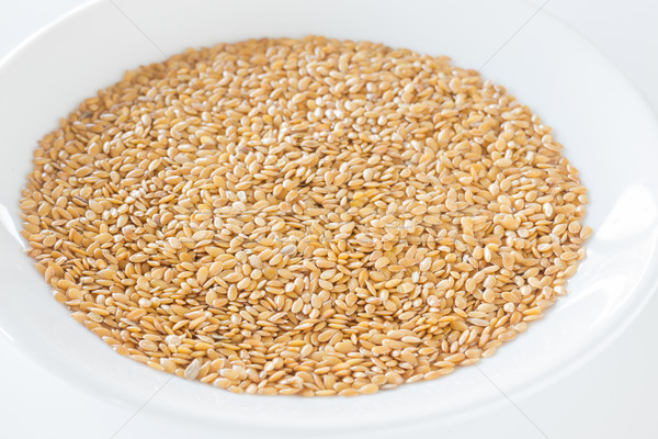 Organic gold flax seeds on a plate Stock photo © nalinratphi