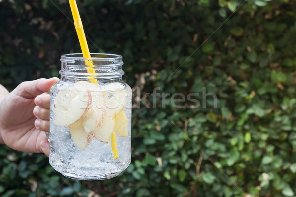 Hand hold glass of iced apple soda drink Stock photo © nalinratphi