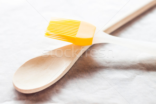 Spoon and brush on baking paper Stock photo © nalinratphi