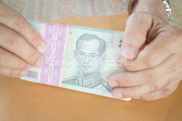 Man hand counting Thai baht banknote  Stock photo © nalinratphi