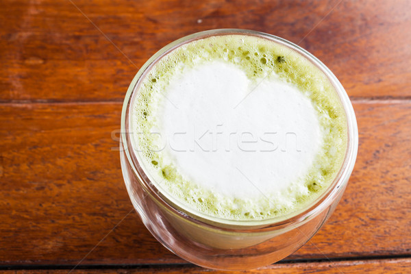 Hot matcha green tea latte on wooden table Stock photo © nalinratphi