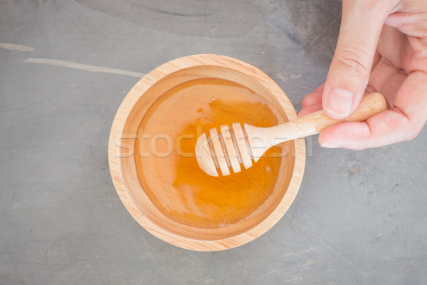 Hand on honey dipper top view Stock photo © nalinratphi