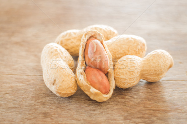 Salted peanuts on weathered wood Stock photo © nalinratphi