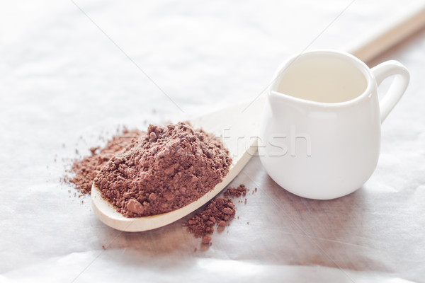 Powdered cocoa ingredient and fresh milk Stock photo © nalinratphi