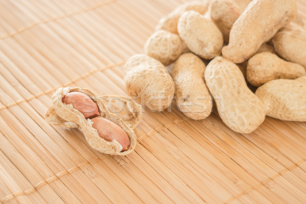 Salted peanuts on kitchen bamboo mat Stock photo © nalinratphi