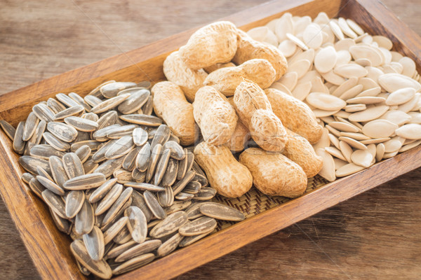 Stock photo: Assorted of whole grain sunflower, peanut and pumpkin on wooden 