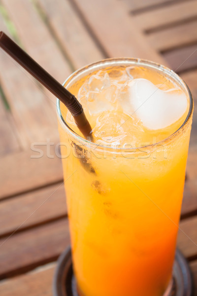 A glass of fresh orange juice on wood table  Stock photo © nalinratphi